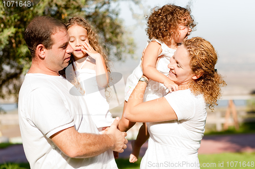 Image of Parents with two kids side view