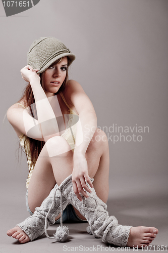 Image of Yound model sitting in autumn clothes