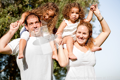 Image of Happy family enjoying in the park