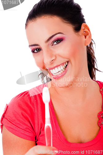 Image of beautiful young woman holding tooth brush and smiling
