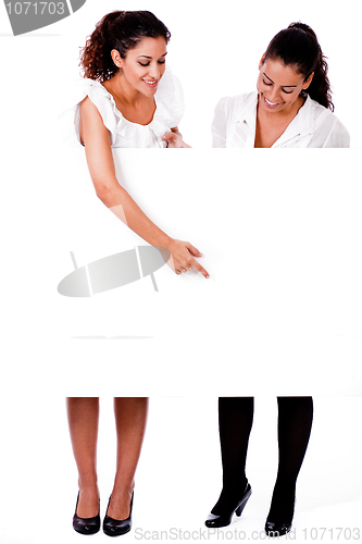 Image of Full length of a Business woman pointing a blank board to her colleague