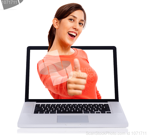 Image of Young girl showing thumbs up getsure through laptop screen
