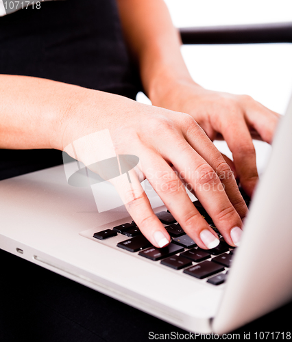 Image of Hands typing on laptop