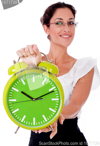 Image of Young business woman showing a green color clock