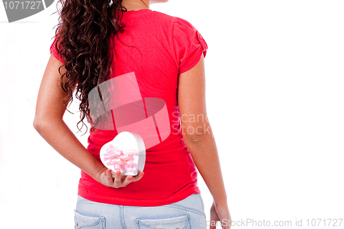 Image of Cute girl hold a heart symbol on her back