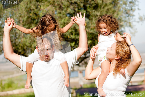 Image of Daughters enjoying their ride on parents shoulders