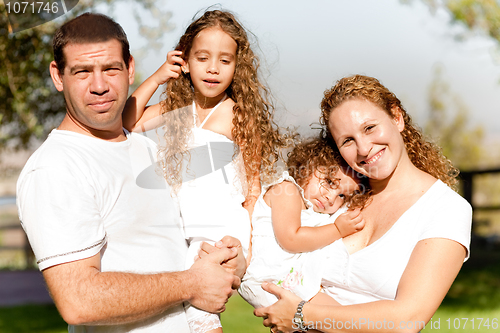 Image of Caucasian happy family in the park