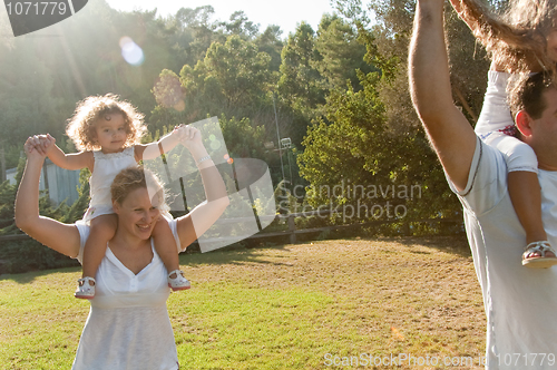 Image of Parents giving a shoulder ride to kids