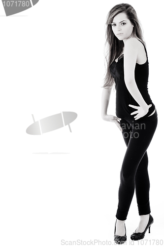 Image of Fitness brunette standing and looking at the camera