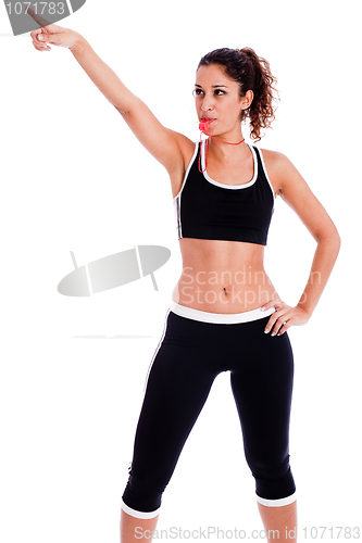 Image of Young fitness woman pointing up the right corner