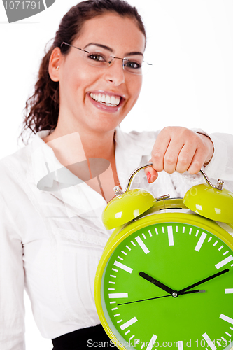 Image of Young happy woman carrying a old clock