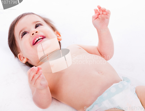 Image of Playful baby lying with has hands up