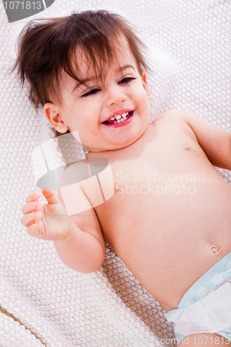 Image of Baby laughing after the bath in a white towel