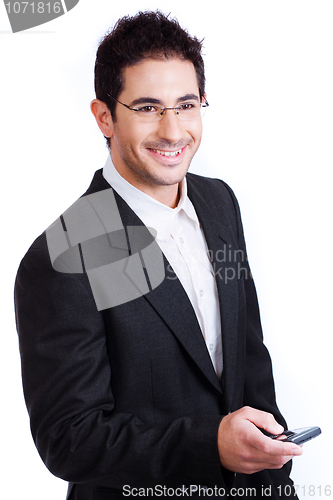Image of Young attractive business man holding a mobile and smile