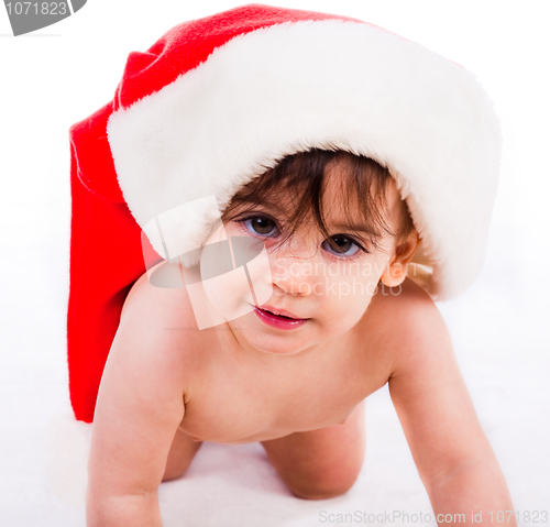 Image of baby in santa hat crawling