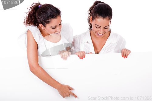 Image of Business woman pointing a blank board to her colleague