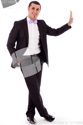 Image of Full body of a business man standing against the wall