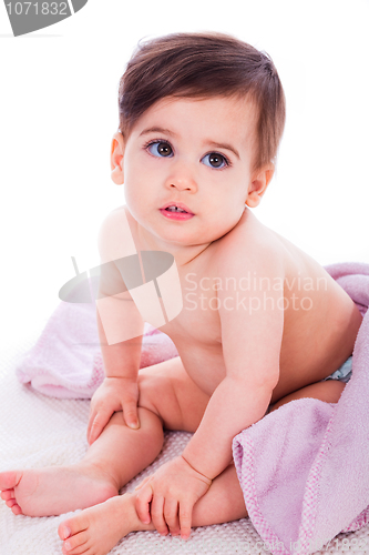 Image of Little baby bending down and covered with towel