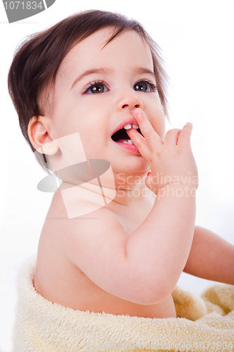 Image of Baby with finger in mouth looking up