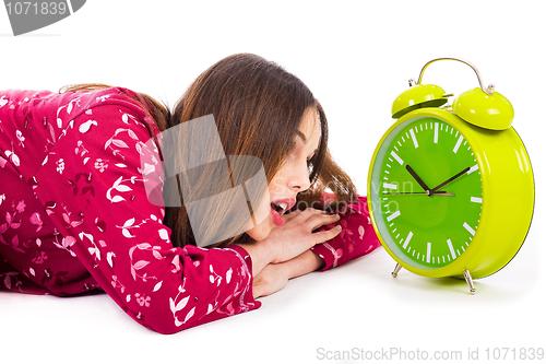 Image of Girl looking into the alarm while its ringing