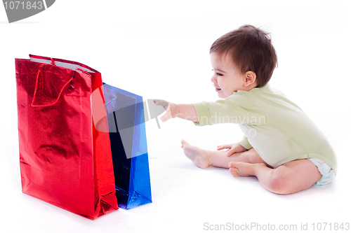 Image of Baby trying to pull the shopping bag