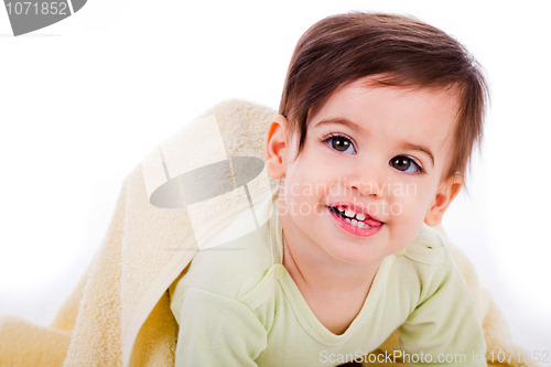 Image of Infant crawling with towel and smiling