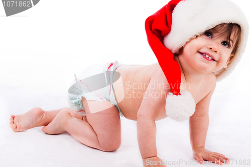 Image of Baby crawling with santa cap