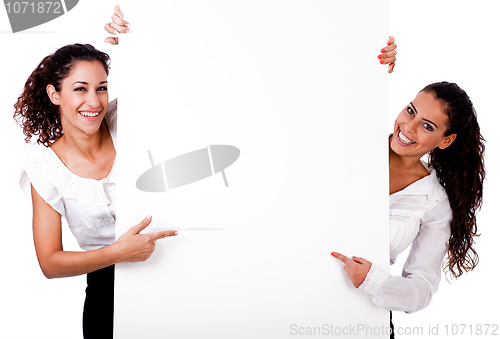 Image of Playful young business colleague pointing the blank white board