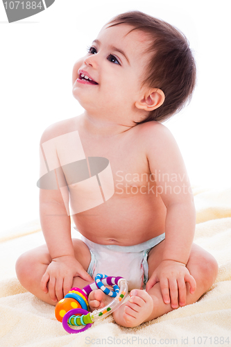 Image of Baby sitting with toys and smile