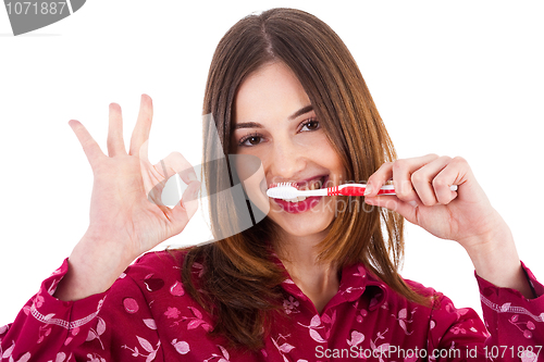 Image of Women brushing her teeth and showing perfect gesture