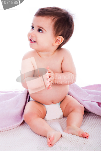 Image of Baby sitting with a purple towel