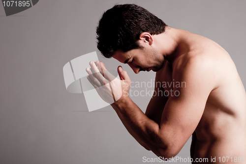 Image of Shirtless man praying