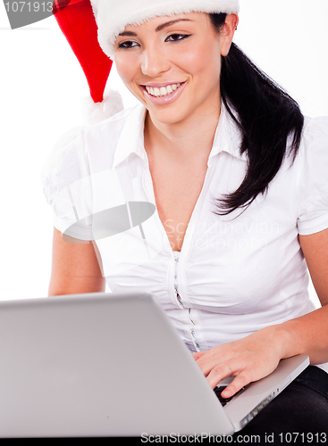 Image of Young santa girl browsing the net