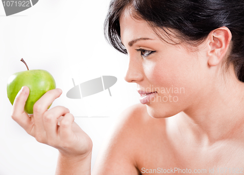Image of Beautiful woman holding a green apple
