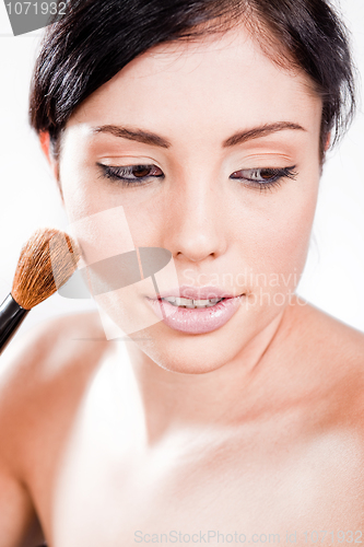 Image of Pretty woman applying make up