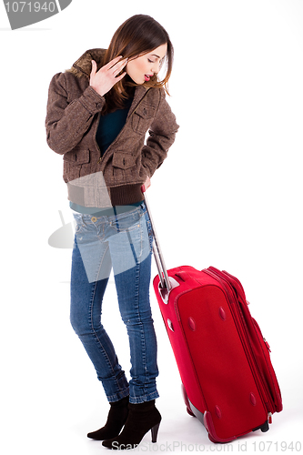 Image of Women ready for travel and looking her luggage