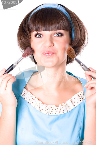Image of woman in blue dress with two make-up brushes