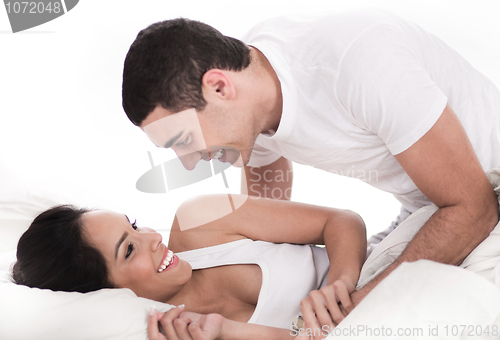 Image of Loving affectionate couple in bed