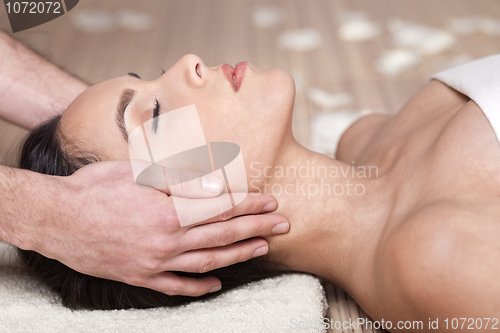 Image of Happy woman receiving head massage