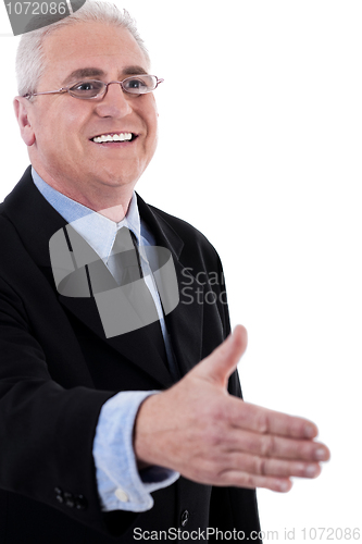 Image of Senior business man holding out his hand for a handshake
