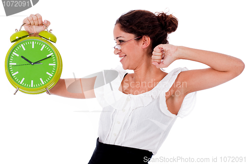 Image of Shot of a Young business woman holding clock