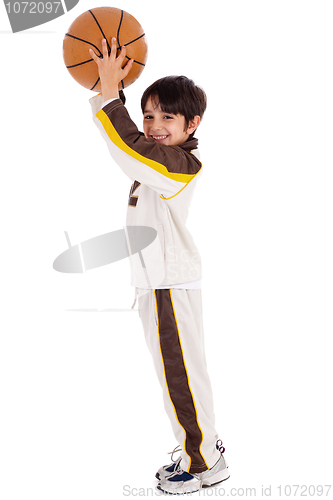 Image of young caucasian boy while playing basket ball