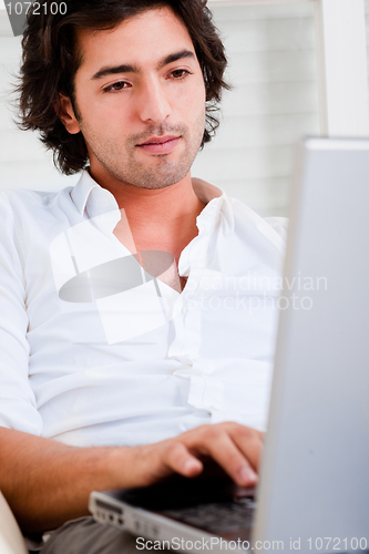 Image of Attractive young man browsing the internet