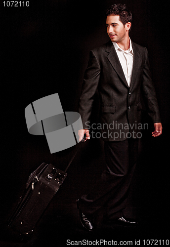 Image of Business man pulling his luggage