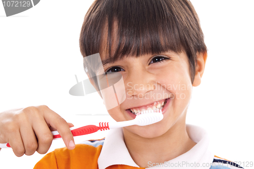 Image of Closeup of cute kid brushing his teeth