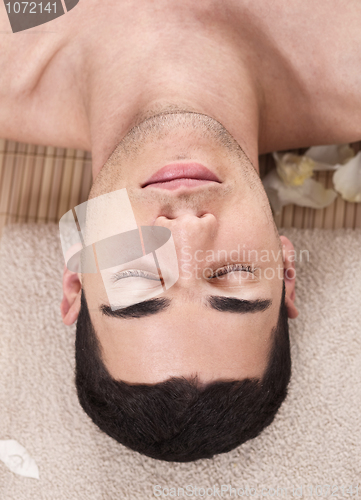 Image of Caucasian handsome spa man ready to take massage