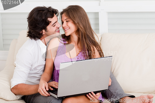 Image of romantic young couple with laptop