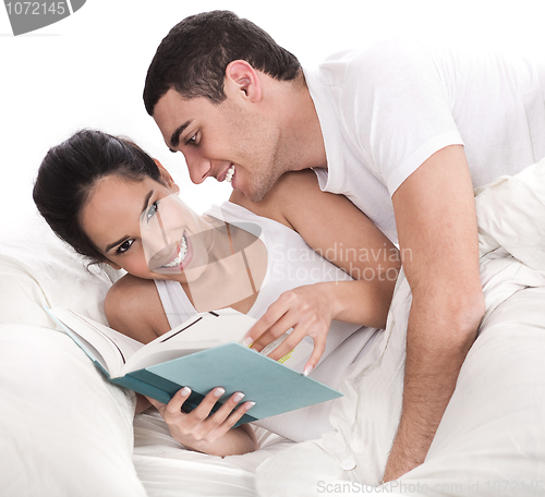 Image of Woman reading dairy, affectionate man trying to kiss her