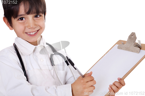 Image of Little boy doctor writes on his clipboard for diagnosis
