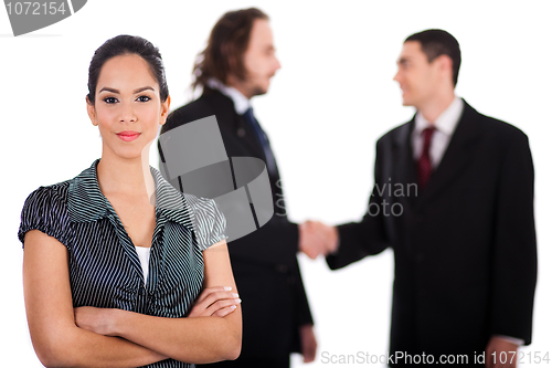 Image of Smiling business women in focus with two business collegue welcoming each other